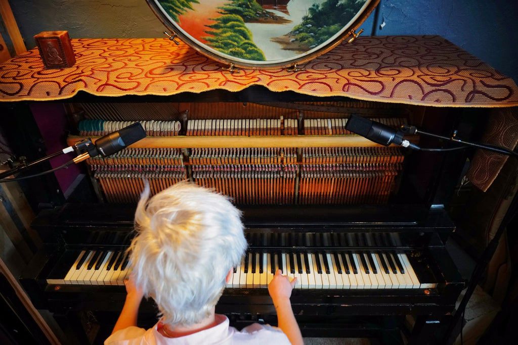 sE Electronics X1 S condenser microphone on a piano, showcasing its sleek design and professional build quality.