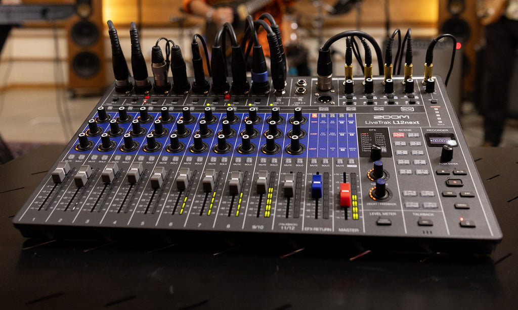 Zoom LiveTrak L12next digital mixer with multiple input channels, knobs, and touchscreen interface, designed for professional audio mixing.